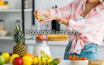 lady putting fruits in mixture